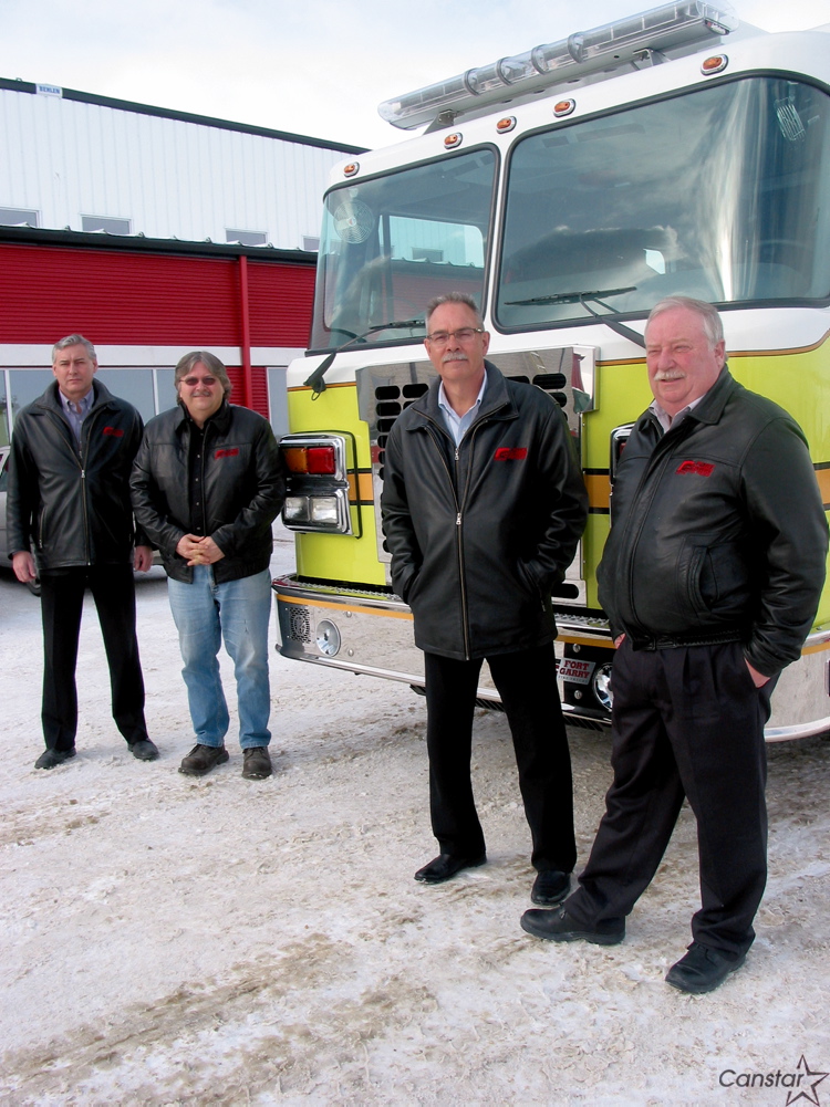 Andrea Geary
Fort Garry Fire Truck's operations manager Jim Peters (left), vice-president of the company's rubber division Tony Brelis, national sales manager Brian Nash and president Rick Suche stand next to a new pumper truck destined for Leduc. Alta.
