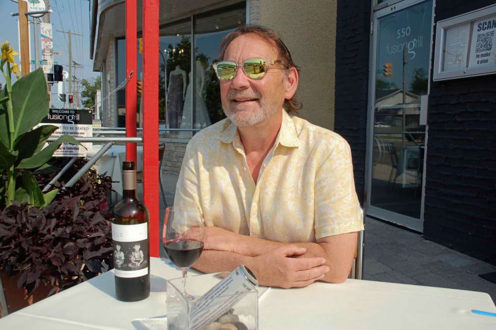 John Kendle
Scot McTaggart is eager to welcome diners to the outdoor patio at Fusion Grill on Academy Road as the restaurant celebrates 25 years of service.
