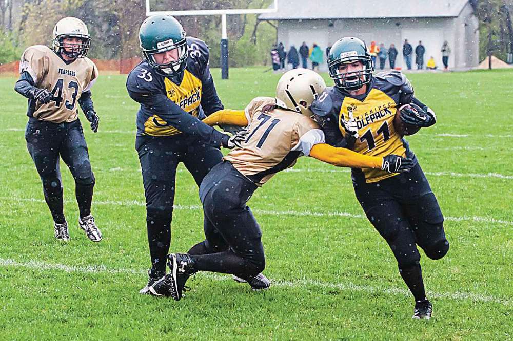 Photo courtesy of Adam Neish
Wolfpack slot receiver Lauren Anderson provides a block as running back Adrienne Chubala attempts to break a tackle during a 19-6 win over the Manitoba Fearless on May 17.