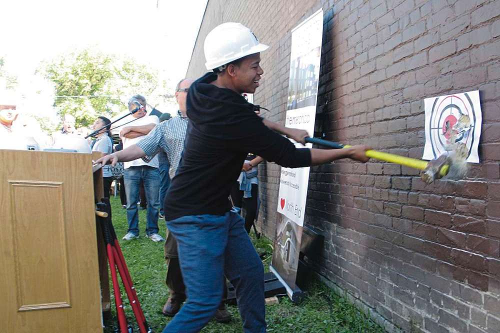 Photo by Jared Story
Urban Circle Training Centre student Julius Stewart was one of many community members to take a swing at the old Merchants Hotel. The once notorious Selkirk Avenue location is being transformed into an education/housing complex.