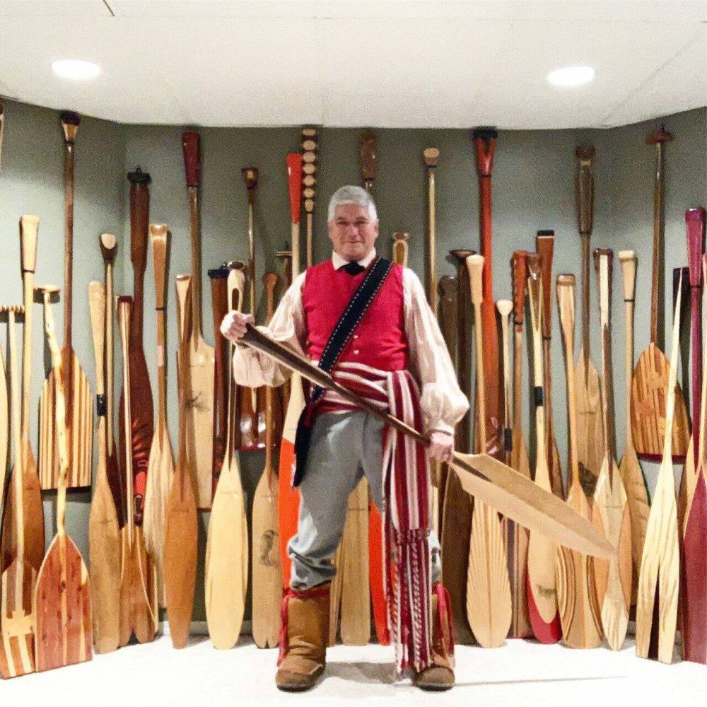 Mark Blieske is pictured with some of the many canoe paddles he has made over the years.