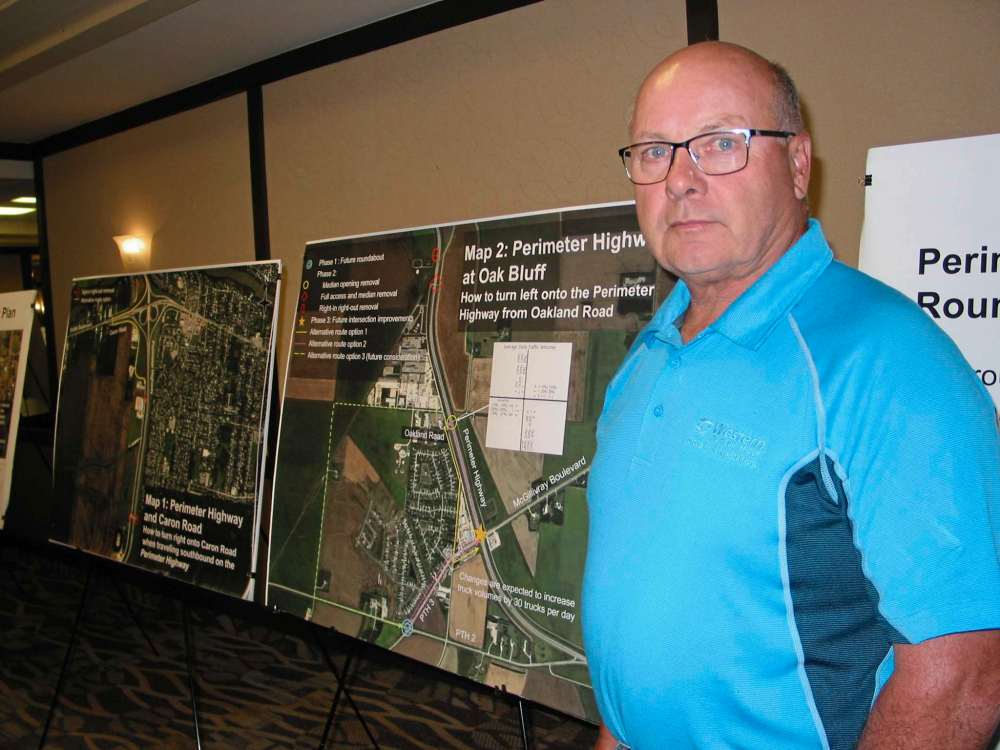 Canstar file photo
Macdonald councillor Doug Dobrowolski stands next to a display board showing proposals for changes in truck traffic coming from Oak Bluff industrial park at a Manitoba Infrastructure information session in May.