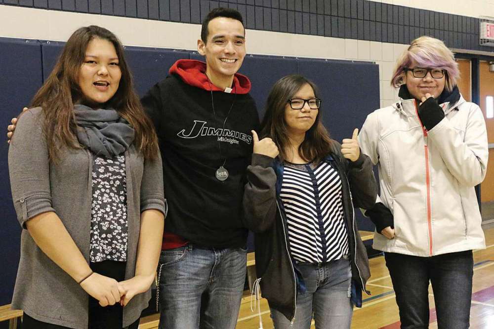 Photo by Christina Hryniuk
St. James Collegiate sudents get a chance to meet with activist and public speaker Michael Champagne on Dec. 13. From left to right: Melissa Labbott Ottertail, 17, Michael Champagne, Renée Daniles, 17, and Farron Okmeow, 17.