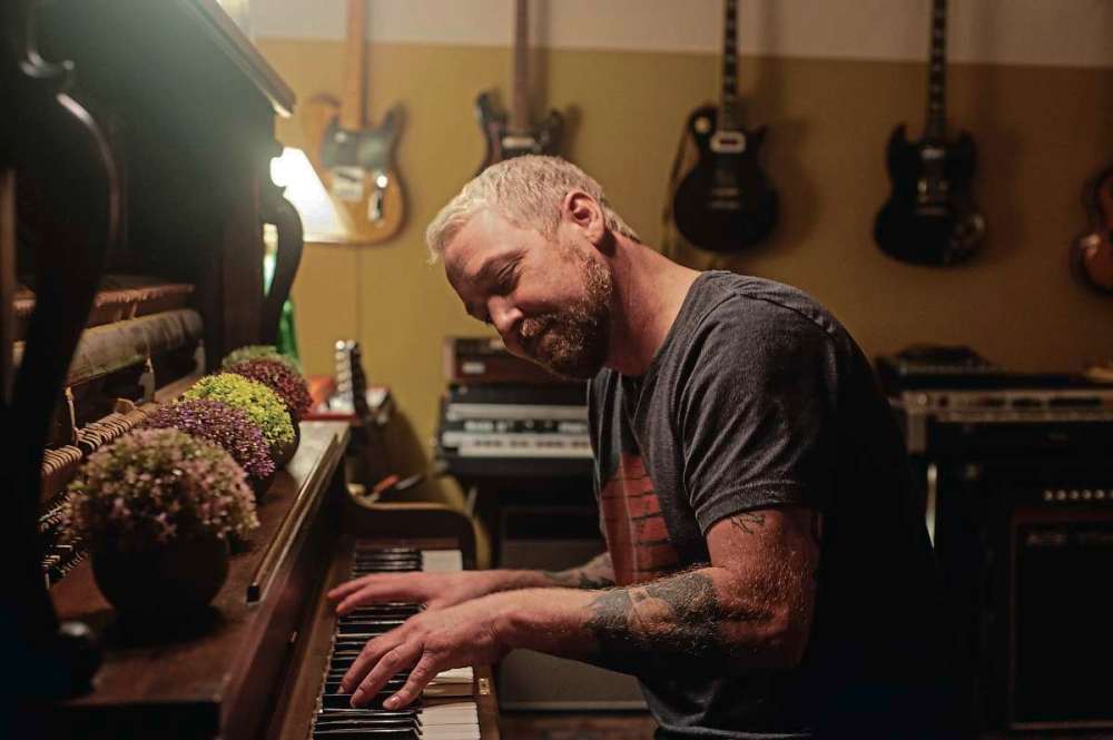 Photo by Cody Sellar
Rusty Matyas plays piano at Argyle Studio. He's a recent arrival to the studio owned by Cam Loeppky. The studio is housed in a warehouse formerly for mobile campers and provides warmth to an otherwise cold building.