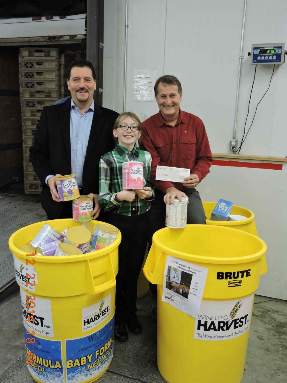 Supplied Photo
Atticus McIlraith (centre) is pictured here with Walt Morris (left) of Walt Morris Group of Companies and David Northcott (right) executive director of Winnipeg Harvest dropping off the baby formula McIlraith collected.