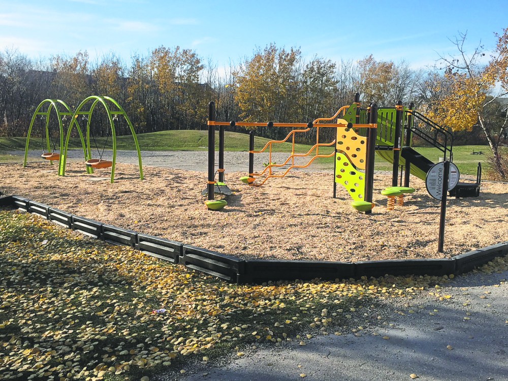Supplied photo
Parents and children in Fort Richmond recently celebrated the completion of a years-long playground rehabilitation project. The $230,000 project at Dalhousie School included three structures with slides, swings and climbing components.