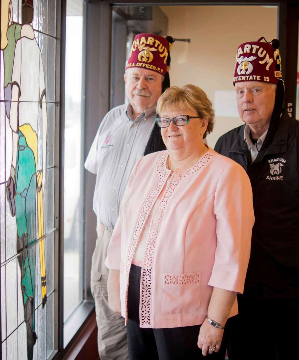 Danielle Da Silva - Sou'wester
From left, Don Thomson, Brenda McKechnie, and Doug McKechnie are pictured in the lobby of the Khartum Shriners Manitoba Northwest Ontario temple on Wilkes Avenue. The Shrine is having a public barbecue on June 2 and is inviting past patients, families, and staff of the Shriners Hospital for children to attend for a reunion.