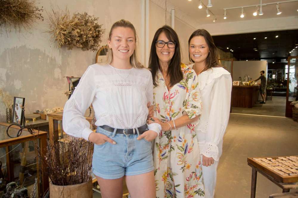 Danielle Da Silva - Sou'wester
Judy Coy (centre), owner of Silver Lotus and Rooster Shoes in Osborne Village, has opened a third storefront called Small Mercies. The new space features handmade housewares, designer jewelry, and a cafe and courtyard that will be home to pop-up shops and community organization programming. Pictured on either side of Coy are her daughters Georgia Prins-Coy (left) and Hannah Prins-Coy inside Small Mercies.