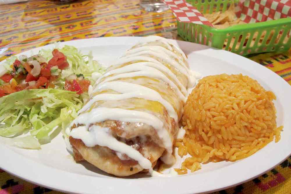 Photo by Kathryne Grisim
The shredded pork enchilada at Vamos Taco is scrumptious, with a subtly spiced filling and a from-scratch sour cream sauce that brings everything together.