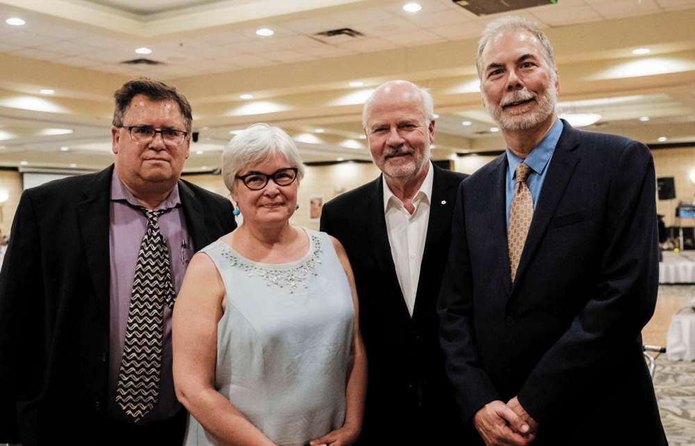 Photo by John Hindle
(From left): John Helliar, president of Share the Magic book program, Chris Melnick, Peter Mansbridge and John Hutton, executive director of the John Howard Society of Manitoba.