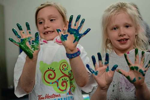 Eva Wasney
Dana Larson and Lily Rogowsky, participants in the Girl Guides Sparks group that meets at Deer Lodge Community Centre once a week, show off the results of a finger painting activity.