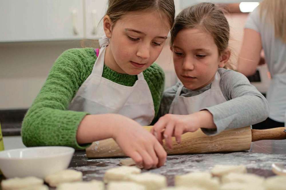 Eva Wasney
Peyton and Taylor McMillan prepare hot crossed buns during the Westdale Community Centre's Kids in the Kitchen program.