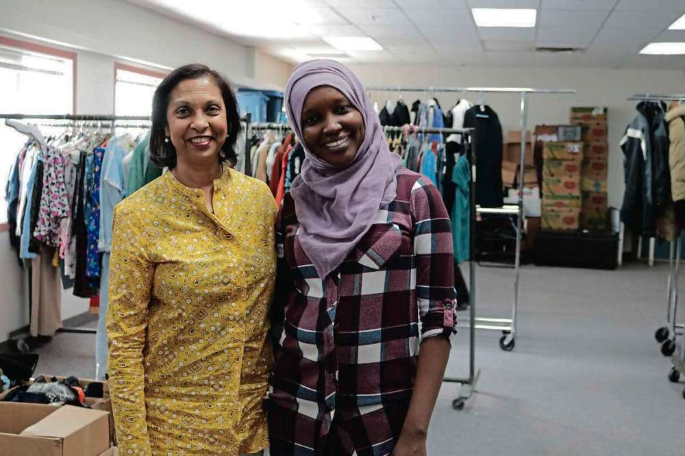 Ligia Braidotti
Canadian Muslim Women’s Institute president Yasmin Ali and staff member Emita Mahmat in front of the racks of clothing they received over Louis Riel Day.