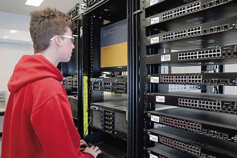 Photo by Ligia Braidotti
Dylan Bucci works on the servers that were donated to the school a few years ago.
