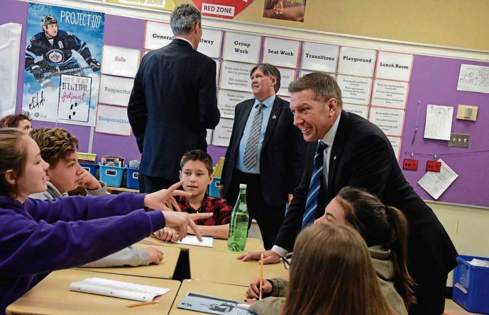 SUPPLIED PHOTO
Above, former NHLer Sheldon Kennedy chats with kids in Meghan McOmber’s Grade 7 class at Bernie Wolfe Community School (95 Bournais Dr.), with Premier Brian Pallister and education minister Ian Wishart in the background.