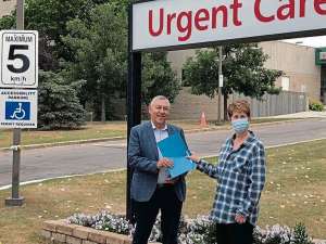 Supplied photo
Karmel Schreyer (right) presents a petition to Elmwood MLA Jim Maloway calling for ambulance fees to be eliminated for disabled people and people who are pregnant.