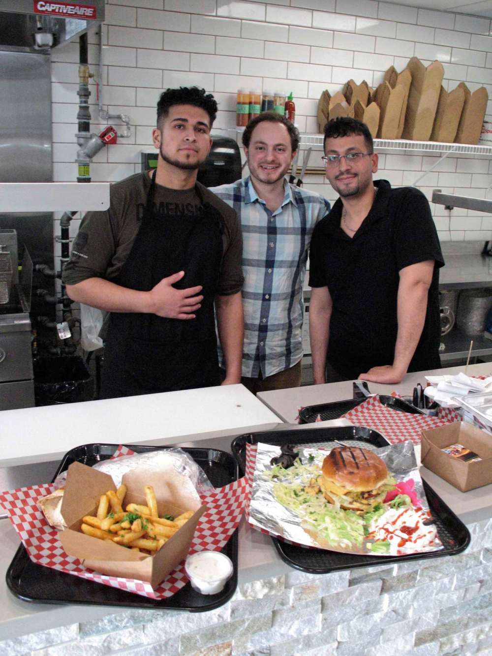 Simon Fuller
From left: assistant manager Malik Abu Yousef; manager Firas Kassem; and chef Ahmet Brimo are pictured at Lamar Donair & Burgers. The new St. Vital-based restaurant opened its doors in late April. (SIMON FULLER/CANSTAR NEWS/THE LANCE)