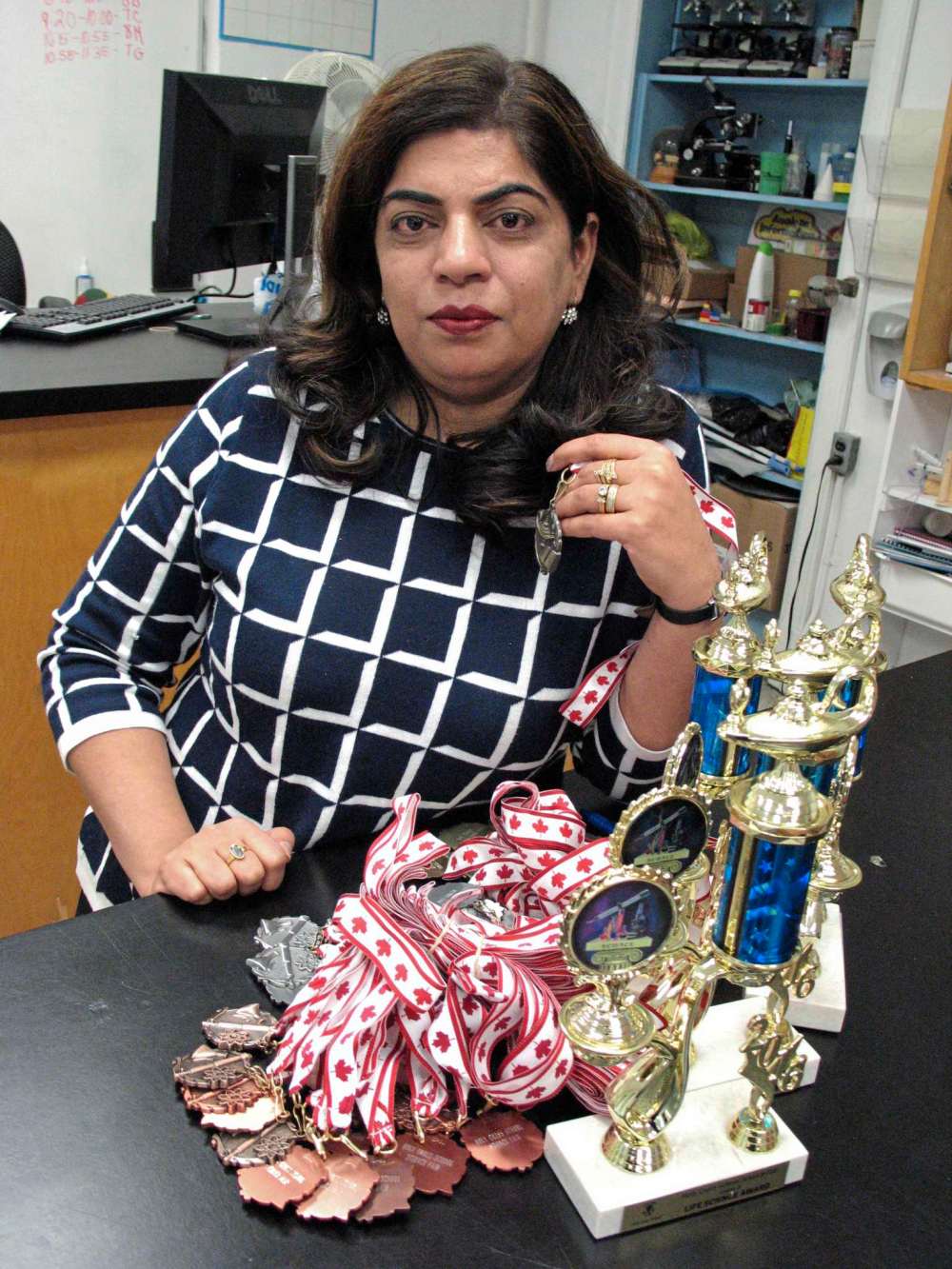File photo by Simon Fuller
In this file photo, Dr. Anju Bajaj is pictured at Holy Cross School with some medals and trophies that were set to be given out at that year’s Bison Regional Science Fair. This year’s fair has been cancelled in the wake of COVID-19, but the YSC Online STEM Fair is currently being held.