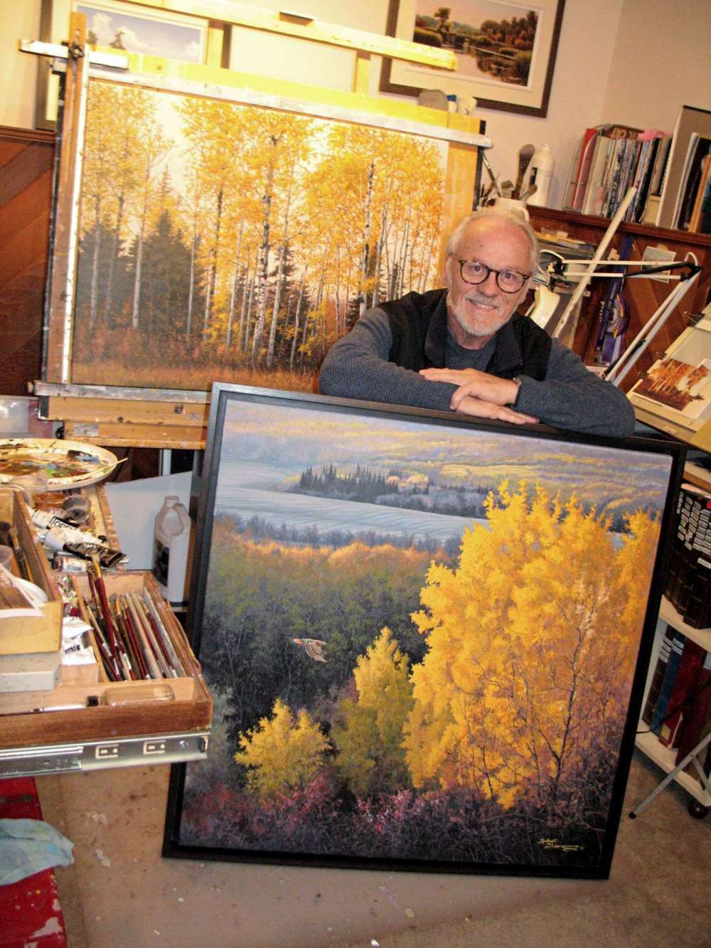 Simon Fuller
Hubert Théroux is pictured with two of his paintings. The Southdale resident is busy preparing for an exhibit at the Centre culturel franco-manitobain that will open on Dec. 10. (SIMON FULLER/CANSTAR NEWS/THE LANCE)