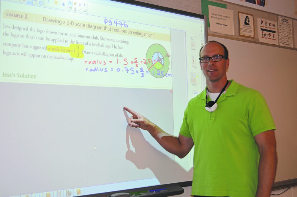 Photo by Sarah Petz
Math teacher Keith Goetz demonstrating how he uses voice recording technology to create virtual lessons for his students.