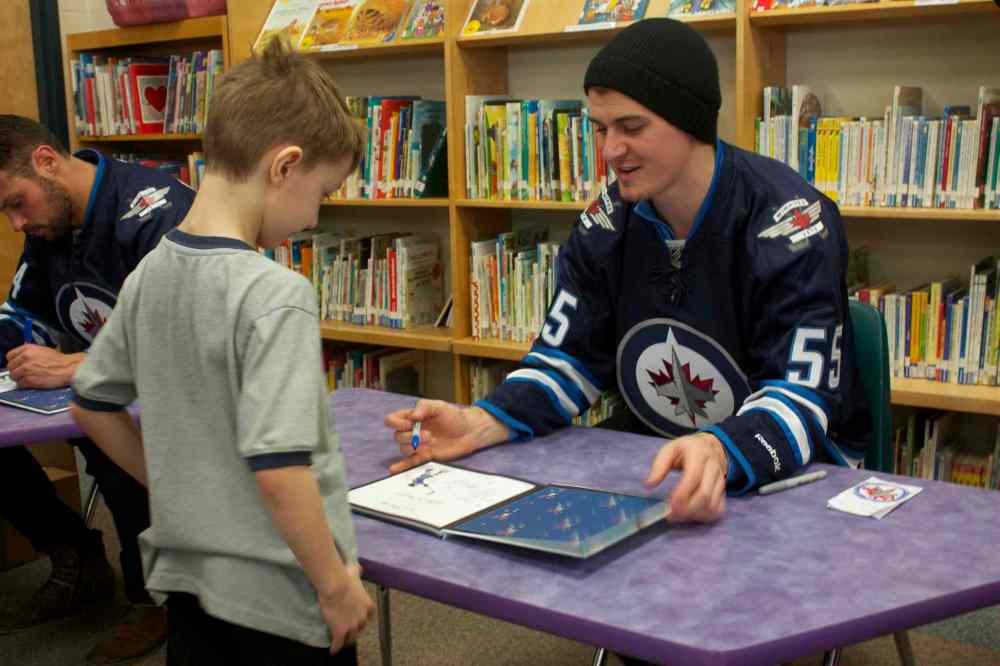 Photo by Dan Falloon
Winnipeg Jets centre Mark Scheifele signs a copy of The Home Team for a young fan at Princess Margaret School on Feb. 25. Scheifele and defenceman Zach Bogosian attended the I Love to Read Month event through the team's Reading Takes Flight program.