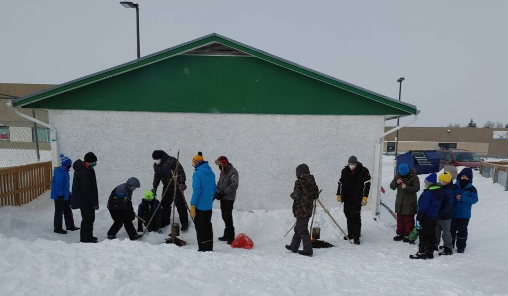 Supplied photo
                                The 1st John de Graff Scouts, pictured here starting fires and boiling water preparing for the annual Klondike Derby, with the Valley Gardens Community Centre’s Lodge in the background. The scouts also used the building for storage. However, the scouts are now in need of a new place to store their equipment year round.