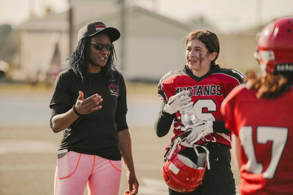 Supplied photo
Patricia Eko-Davis is pictured on the field with the St. Vital Mustangs junior girls team she coaches.