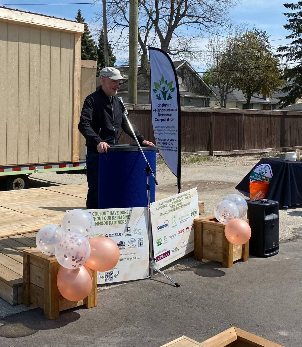 Photo by Sheldon Birnie
Michel Durand-Wood, chair of ReImagine Elmwood and the Glenelm Neighbourhood Association, spoke at the grand opening of a new outdoor public space at 243 Henderson Hwy.