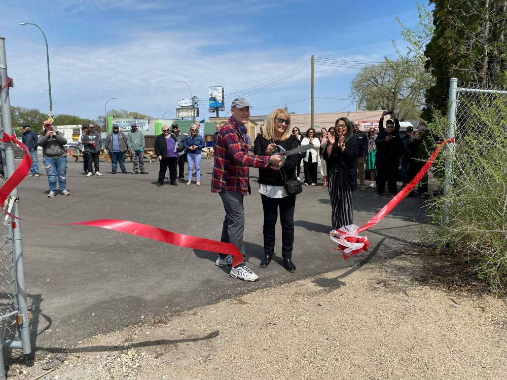 Photo by Sheldon Birnie
Coun. Jason Schreyer (Elmwood-East Kildonan) and Celia Patrician, real estate/asset manager for Suncor, officially cut the ribbon at 243 Henderson Hwy., a new outdoor community space for local organizations and businesses, while Leilani Esteban Villarba, executive director of Chalmers Neighbourhood Renewal Corporation looks on.