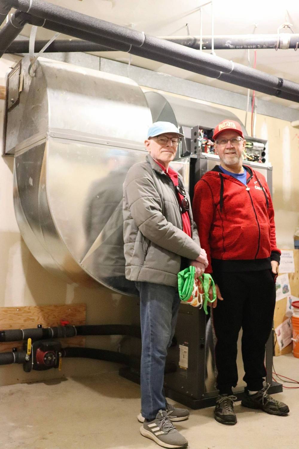 Photo by Emma Honeybun
United Church in Meadowood congregation members Peter Kidd (left) and Doug Purdey are pictured recently in front of a new piece of geothermal installation.