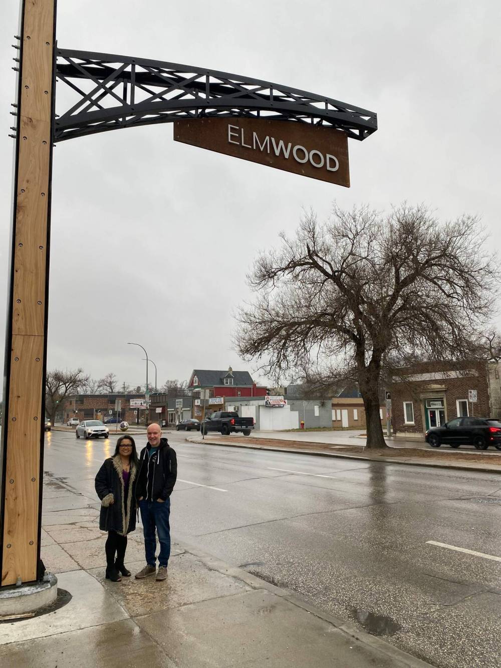 Photo by Sheldon Birnie
ReImagine Elmwood chair Michel Durand-Wood and Leilani Esteban-Villarba, executive director of the Chalmers Neighbourhood Renewal Corporation, stand beneath one of two new Elmwood archways on Henderson Highway.