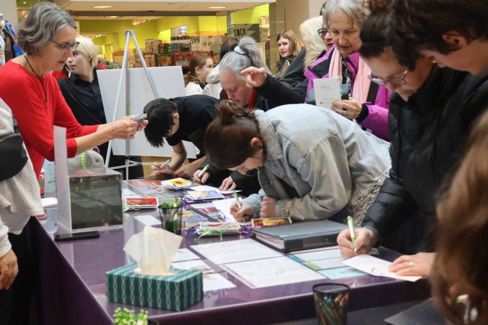 Photo by Emma Honeybun
Palliative Manitoba’s memory tree was officially launched for the holiday season at St. Vital Centre on Nov. 28. At the event, people were busy filling out cards in memory of lost loved ones (pictured).