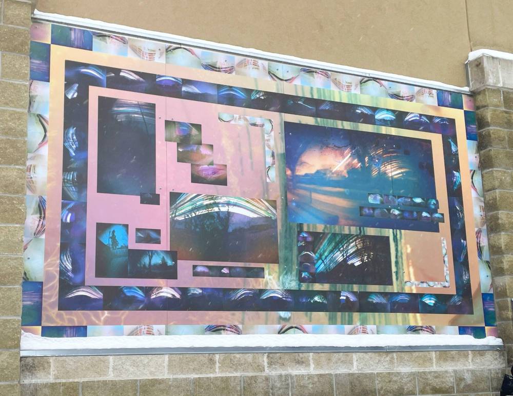 Photos by John Kendle
Gathering Light: Capturing Community is a pair of photo-collage panels on the north exterior wall of the gym at the Isaac Brock site of Valour Community Centre. The pieces were created by members of the South Valour Residents Association, in collaboration with visual artist Sarah Crawley, through the Winnipeg Arts Council’s With Art program.
