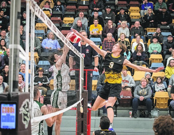 Free Press file photo – Steinbach Sabres’ Nik Reimer spikes the ball against the Vincent Massey Trojans during the 2022 AAAA high school volleyball varsity boys semi-finals. This year's boys and girls AAAA finals are tonight at Investors Group Athletic Centre.