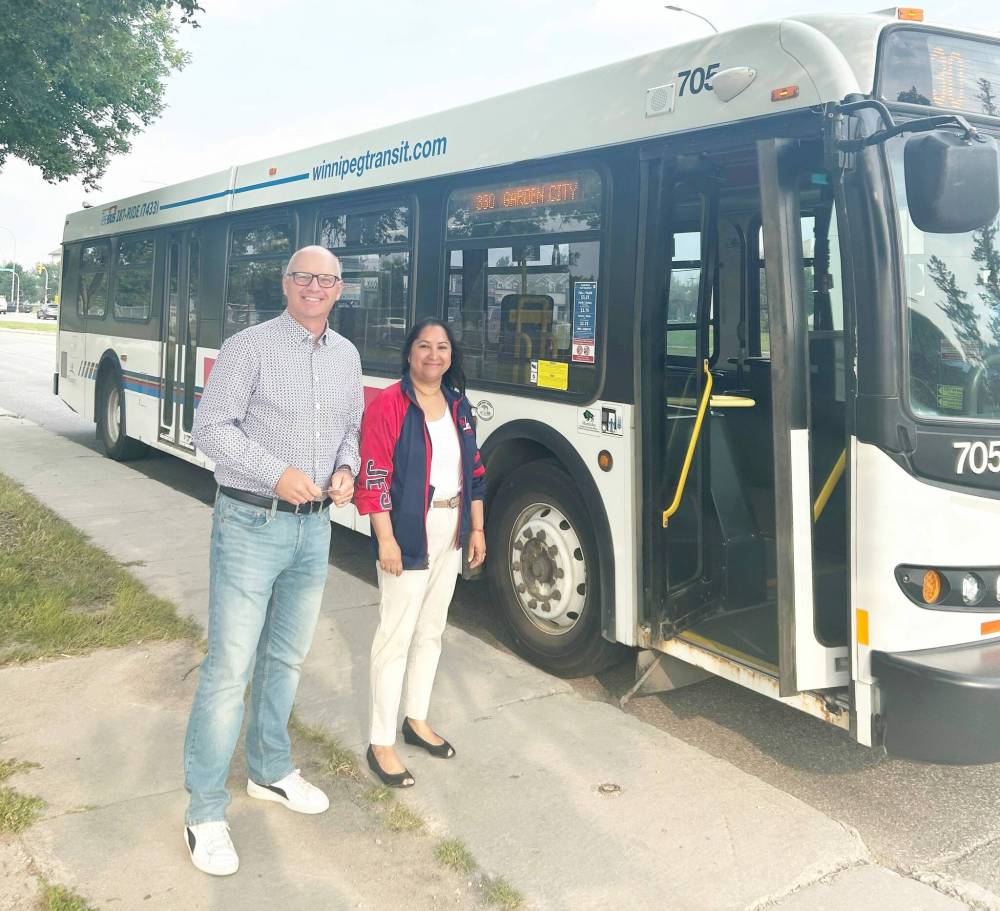 Supplied photo
Winnipeg mayor Scott Gillingham and councillor Devi Sharma get ready to board a bus in the Old Kildonan ward.