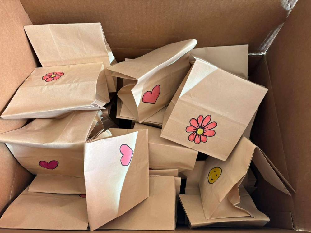 Photo by Janine LeGal
The hearts of some people are so big they insist on doing as much as they can — like baking and packaging bananaa chocolate chip muffins for distribution on a downtown community walk.