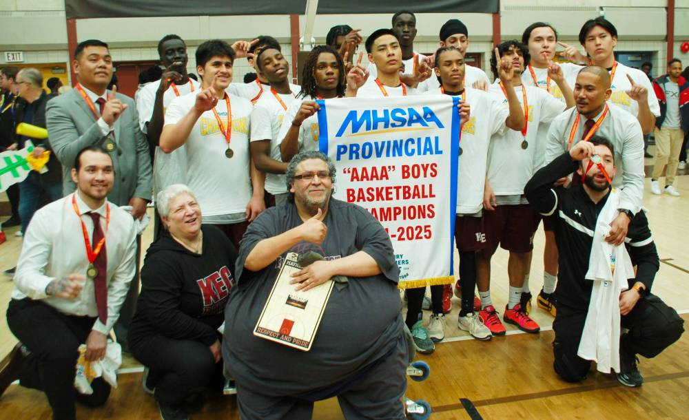 Photos by John Kendle
Members, staff and coaches of the Kildonan East Reivers varsity boys basketball team pose for a group shot after the Reivers defeated the Dakota Lancers 67-52 to win the Manitoba High Schools Athletic Association’s varsity boys AAAA championship on March 24 at the Investors Group Athletic Centre.
