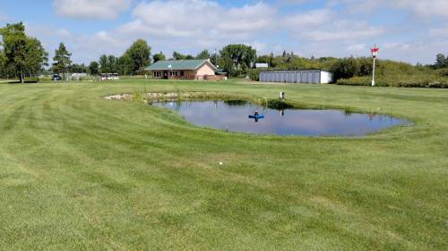 Photo by Ryan Desjarlais
                                The walk back along the ninth hole of the Hamiota Golf Course to the clubhouse, or parking lot depending on hours, offers a fountain feature in the middle of the centred hazard that lies 70m shy of the green.