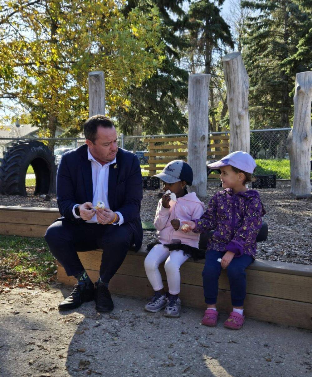Supplied photo
MLA Logan Oxenham enjoying cupcakes with kids in the new play space at the YMCA-YWCA daycare in Kirkfield Park.