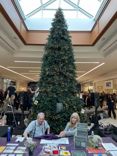 Photo by Simon Fuller
                                Two Palliative Manitoba volunteers are pictured shortly before the memory tree opened to the public on Nov. 27. Visitors can write messages on cards and attach them to the tree, taking time to reflect on the memory of a lost loved one, until Dec. 23.