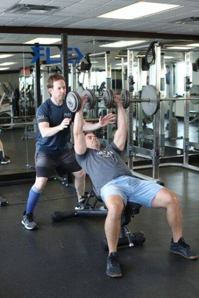 Supplied photo
                                Alistar Hopper of Flex Fitness works with a client.