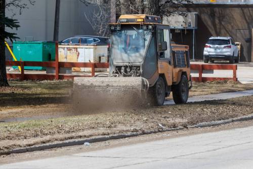 Mike Deal / Free Press
                                A sidewalk cleaner works in a city neighbourhood late last month. Homeowners are advised to check the Know Your Zone app to learn when their streets will be cleaned.