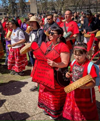Supplied photo
                                Attendees wore red and held signs of solidarity at the 2025 Red Dress Day community walk.
