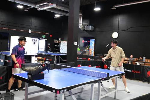 Photo by Rylee Gerrard
                                Can&rsquo;t find someone to play with at The Pong Room (1146 Waverley St.)? Try playing with the robot Terry Zhang is pictured playing with here.