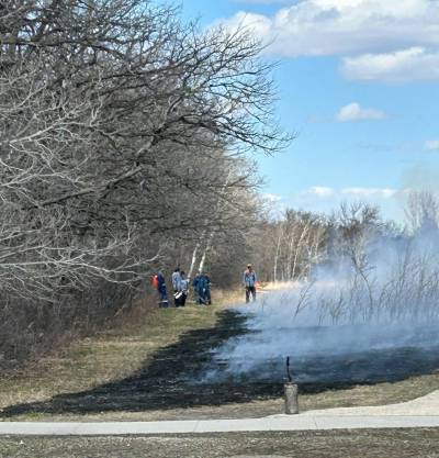 Photo by Tanya Misseghers
                                City of Winnipeg crew conducting a controlled burn earlier this year in Royalwood.