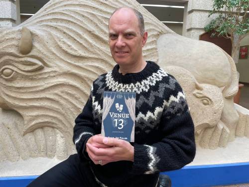 Photo by Simon Fuller
                                Writer David Jón Fuller is pictured recently with a copy of his debut novel Venue 13.