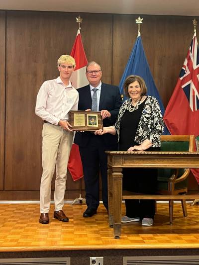 Supplied photo
                                Elliot Smith, left, is one of four recipients of a $2,000 Manitoba High Schools Athletic Association scholarships this year. He is pictured receiving his award from Tim Klassen, representing award sponsor Manitoba&rsquo;s Credit Unions, and the Hon. Anita R. Neville, Lieutenant Governor of Manitoba.