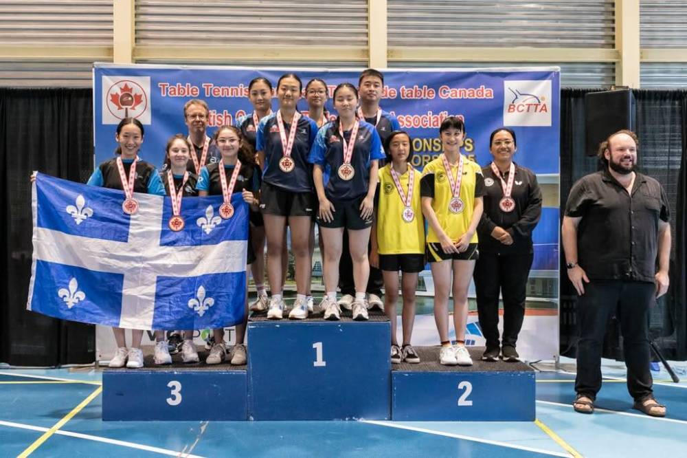 Photo by Table Tennis Canada U-15 team athletes Alexus Lee, Rhea Liu and coach Nury Vasquez on the podium where they finished with a silver medal at the 2025 Canadian Championships in Richmond, B.C.