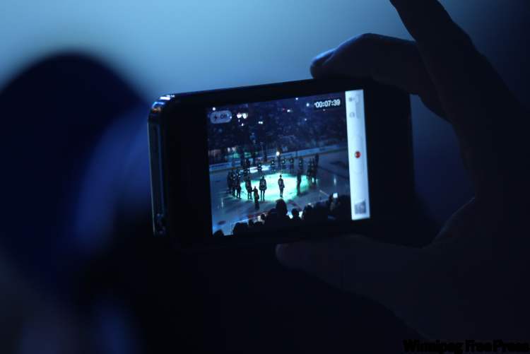 Joe Bryksa / Winnipeg Free Press
A fan records the opening ceremonies before ytthe Winnipeg Jets take on the Montreal Canadiens at the MTS Centre Sunday.