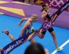 Switzerland's Nicola Spirig, right, finishes ahead of Sweden's Lisa Norden to win the gold medal in the women's triathlon at the 2012 Summer Olympics, Saturday, Aug. 4, 2012, in London. Norden took the silver. (AP Photo/Charlie Riedel)